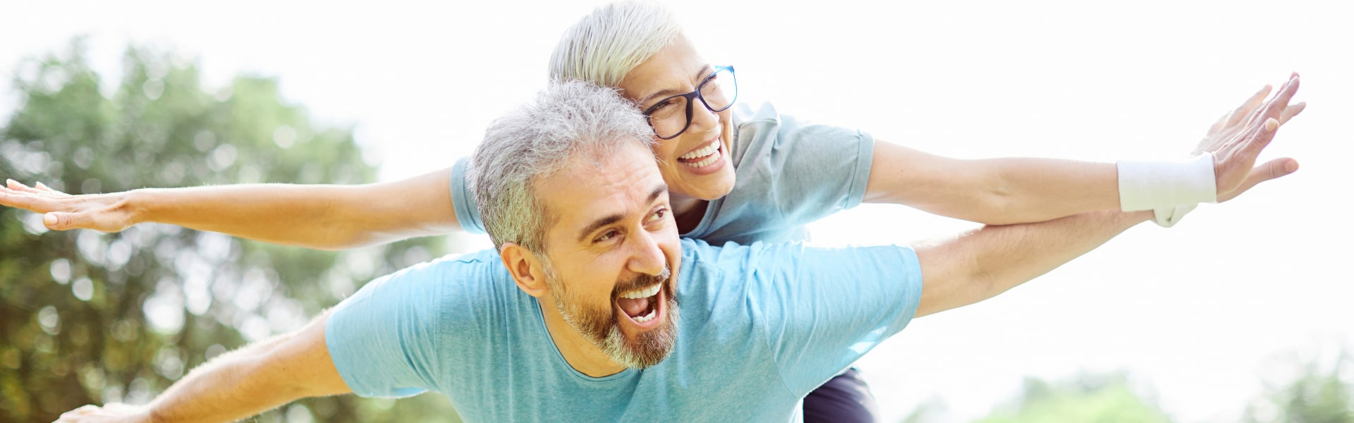 Smiling active senior couple having fun exercises