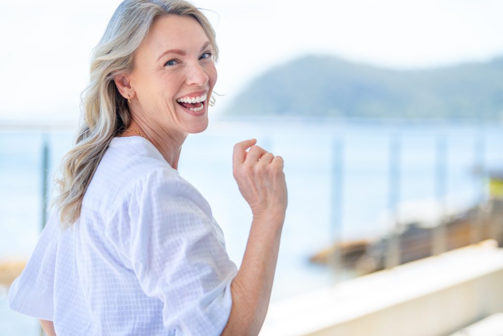 Beautiful mature woman portrait at waterfront house.
